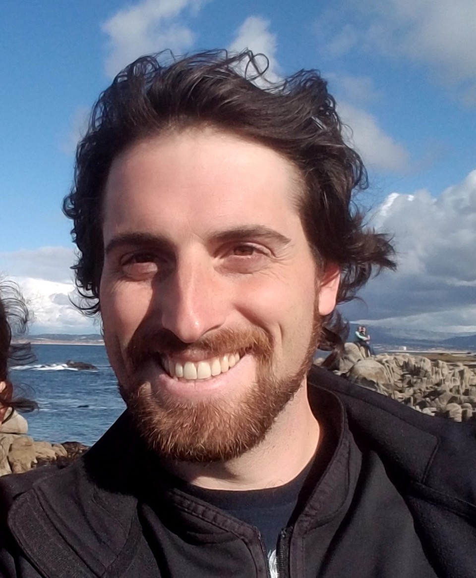 A photograph of David Prina outside.